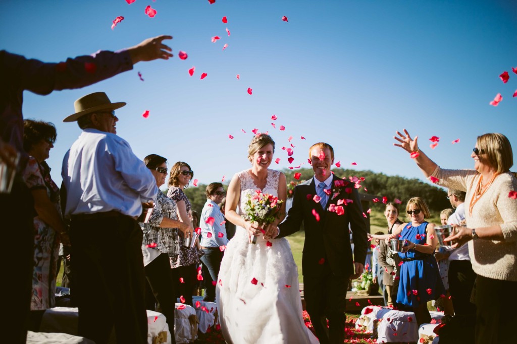 Rose Petals being thrown as the newlyweds walk back down the aisle.