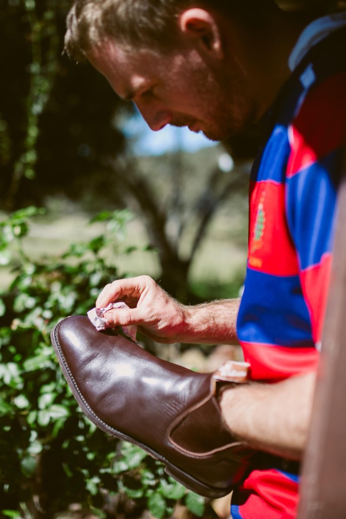 Andrew - the best man, polishes his boots.