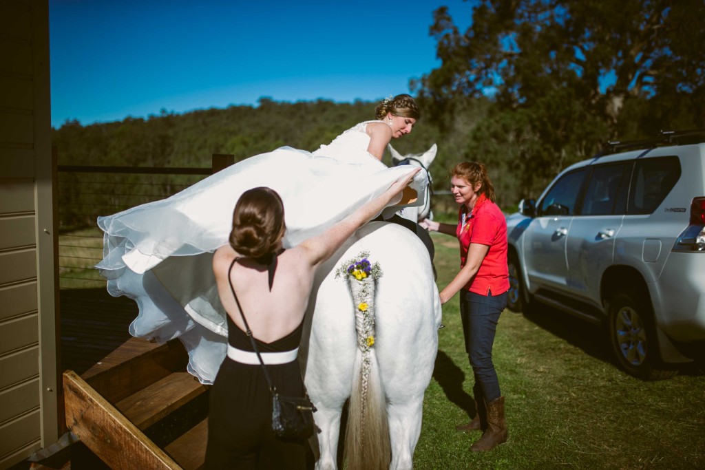 How to Mount a Horse in a Wedding Dress! Step 1: Have lots of helpers Step 2: Put foot in stirrup Step 3: Hope for the best!